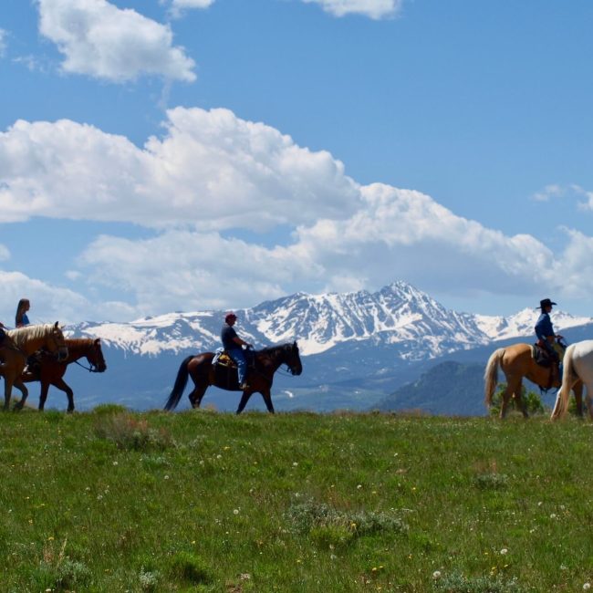 Beginner trail rider family enjoying gentle Colorado horseback riding with guided support at Rusty Spurr Ranch in Kremmling, Colorado.