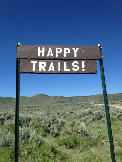 A rustic sign adds charm and humor to the entrance of the ranch, creating a fun atmosphere as soon as guests arrive.