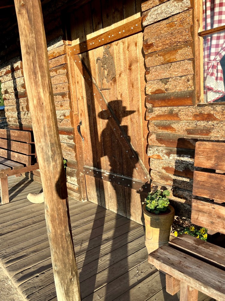 A cowgirl enjoys the afternoon sun at the Rusty Spurr Ranch guest cabin 